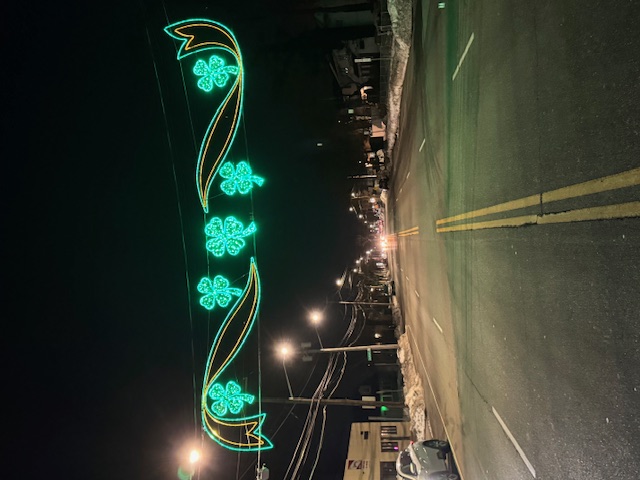 Shamrock street light display spanning across road at night